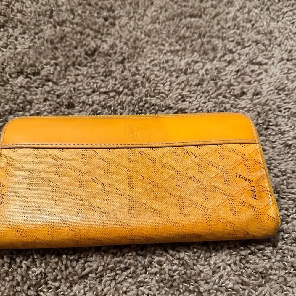 Goyard Matignon zip-around wallet in yellow orange Goyardine canvas.
